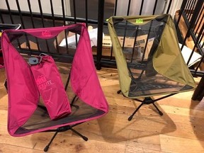 This July 18, 2017 photo taken at the REI store in the Soho neighborhood of New York, shows two Flexlite chairs made by REI. They come in five different colors and are typical of a genre of compact folding furniture that can also be used indoors. (Katherine Roth via AP)