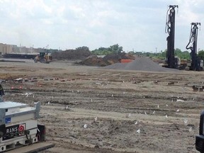 In this July 19, 2017 photo, heavy machinery clearing land at the Interstate 94 Industrial Park in Detroit. The park is former vacant land that the city is marketing to manufacturing and industrial companies. Auto parts supplier Flex-N-Gate is expected to bring 750 jobs to Detroit when it completes its 350,000-square-foot plant at the industrial park. (AP Photo/Corey Williams)