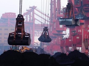 FILE - In this June 6, 2015, file photo, heavy machines move imported iron ore at the dock in Rizhao in eastern China&#039;s Shandong province. China announced Monday, Aug. 14, 2017, it will cut off imports of North Korean coal, iron ore and other goods in three weeks under U.N. sanctions imposed over the North‚Äôs nuclear and missile programs.(Chinatopix via AP, File)