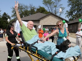 Don Brunelle waves to family and friends as he arrives at his Olive Road home in Windsor on Aug. 25, 2017 after spending three months in hospital following a car crash.