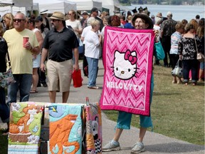 Stephanie McBride displays a handmade quilt for sale on Aug. 26, 2017 during Art by the River,  an event hosted by The Fort Malden Guild of Arts and Crafts and Gibson Gallery.