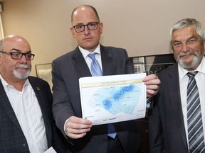 Windsor Mayor Drew Dilkens holds a map showing the pattern of flooded basements across Essex County.  Tecumseh Mayor Gary McNamara, left, and Lakeshore Mayor Tom Bain joined Dilkens on Aug. 31, 2017 to talk about ways to deal with the flooding.