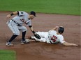 Ian Kinsler #3 of the Detroit Tigers tags out Chris Davis #19 of the Baltimore Orioles trying to steal second base for the third out of the second inning at Oriole Park at Camden Yards on August 3, 2017 in Baltimore, Maryland.