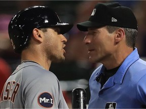 Detroit's Ian Kinsler, left, argues balls and strikes with home plate umpire  Angel Hernandez during a game against the Texas Rangers at Globe Life Park in Arlington, Texas on Aug. 14, 2017.