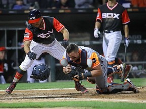 Yolmer Sanchez, left, of the Chicago White Sox is tagged out at the plate in a collision with James McCann of the Detroit Tigers in the seventh inning at Guaranteed Rate Field on Aug. 25, 2017 in Chicago.