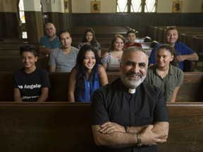 Pastor Elie Zouein sits with immigrants from Syria and Iraq at Saint Peter's Maronite Church, Thursday, August 3, 2017.   Arabic is now the most spoken language in Windsor after English.