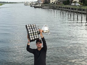 Toronto Maple Leafs prospect and Windsor Spitfires grad Jeremy Bracco hoists the Memorial Cup on his father's boat as the trophy made its first known stop in New York.   Handout photo / Windsor Star