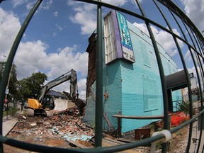 Demolition of the West Windsor landmark Bridge Tavern is nearing the final stages. A heavy equipment operator knocks down the structure on Wednesday, August 23, 2017.  Two musicians who were frequent fixtures at the old tavern prior to its closure in 2007, Mike "Lonesome Lefty" Houston and Kenneth MacLeod, are holding Lefty and Kenneth's Bridge Memorial show on Sept. 1 at The Windsor Beer Exchange on University Avenue West beginning at 9 p.m.