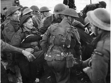 Capt. Hugh Kennedy of Essex Scottish is carried on to a landing craft after being wounded in the Dieppe landing.