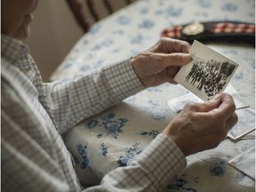 Everett Ross Maracle, 94, possibly the last surviving member of the Essex Scottish Regiment involved on the raid of Dieppe, looks at a photograph taken during the Second World War, while at his home in Redford, Mich. on Aug. 18, 2017.