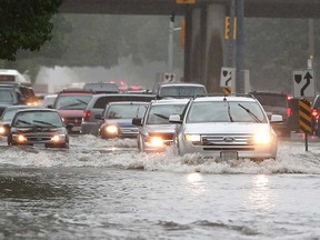 Vehicles are barely able to move on flooded Dominion Boulevard in south Windsor on Aug. 29, 2017.