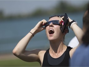 Kailyn Keller, 22, a University of Windsor student, is in awe as she looks up at the sun along Windsor's waterfront during the solar eclipse of 2017, Monday, August 21, 2017.