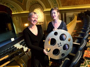 Oona Mosna, right, program director of the Media City Film Festival and festival assistant Sarah Kelly make preparations at the Capitol Theatre on Tuesday. The festival opens its 22nd year on Wednesday.