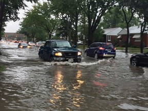 Vehicles struggle to make their way through flooding on Dominion Boulevard in South Windsor on Aug. 29, 2017.