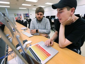 Cai Filiault, left, a mobile applications professor at St. Clair College works with student Simon Lizotte on Thursday, August 3, 2017. The mobile applications development field has been identified as one of the most in demand in the job market.