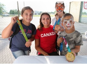 Hanna Skope, 11, Emerson Lobzun-Howe, 10, and William Skope, 7, meet Kylie Masse during a special day dedicated to the Olympic swimmer by the Town of LaSalle.