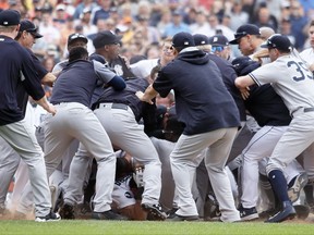 Detroit Tigers' Miguel Cabrera is in the bottom of the pile as the New York Yankees fight with the Detroit Tigers during the sixth inning of a baseball game on Aug. 24, 2017, in Detroit.
