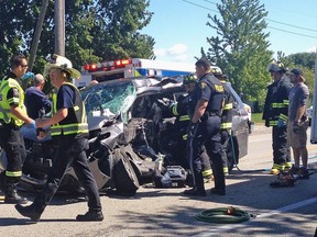Rescue crews, including paramedics, firefighters and police, work at the scene of a motor vehicle collision at the intersection of County Rd. 34 and County Rd. 37, east of Leamington, August 5, 2017. (Reader submitted photo)