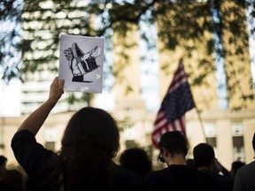 People protest against the white supremacist movement and racism outside the United States consulate in Toronto on Aug. 14, 2017.