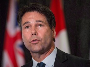 Ontario Health Minister Eric Hoskins speaks during a news conference after the first day of a meeting of provincial and territorial health ministers in Vancouver, B.C., on January 20, 2016. Ontario is putting an additional $222 million over three years toward fighting an opioid crisis in the province.