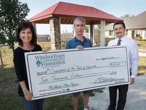 The Honey Family Foundation Fund donated $10,000 to the redevelopment project of Mettawas Park in Kingsville, ON. on Monday, August 14, 2017. Lisa Kolody with the WindsorEssex Community Foundation, Michael Honey, centre, from the Honey Family Foundation Fund and Nelson Santos, Mayor of Kingsville pose with the cheque at the park.