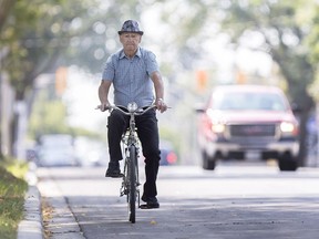 A cyclist rides north on Pillette Road, Monday, August 7, 2017.
