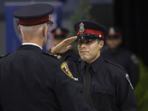 Const. Joshua Koptie salutes Windsor Police Chief Al Frederick at badge presentation ceremony at the Tilston Armouries, Thursday, August 24, 2017.  Five first-class constables and five fourth-class recruit constables received their badges from the Windsor Police Service.