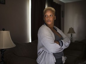 Ann Wilson, who lives in one of the Alix J. Sinkevitch Townhomes at 3380 Ypres Ave., is pictured in her darkened home, Thursday, August 31, 2017.  The 36-unit complex has been without power since torrential rain caused massive flooding on Tuesday.