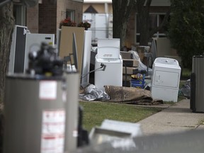 Flood damaged items sit on the lawns of units at the Alix J. Sinkevitch Townhomes at 3380 Ypres Ave. in Windsor on Aug. 31, 2017.