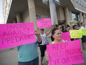 Demonstrators protest police inaction outside Windsor police headquarters, Tuesday, August 8, 2017.