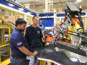 Controls Engineer Nanda Vandala and electrician Michael Hunt at Reko International Group Inc. on August 2, 2017 in Lakeshore, Ontario. The company has announced expansion plans.