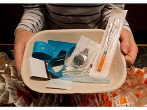 A registered nurse holds a tray of supplies to be used by a drug addict at the Insite safe injection clinic in Vancouver on May 11, 2011. Long approved in B.C., Ontario cities are now looking at setting up supervised safe injection sites to allow people to inject illicit drugs in the presence of medical staff.