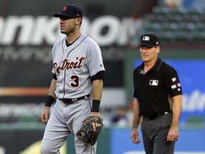 Detroit Tigers second baseman Ian Kinsler stands by second as umpire Angel Hernandez, right, watches play during the second inning of the Tigers' baseball game against the Texas Rangers on Wednesday, Aug. 16, 2017, in Arlington, Texas.
