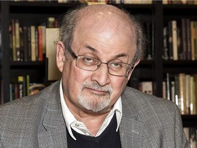 Author Salman Rushdie signs a copy of his new book 'Home' at a book signing in London, Tuesday, June 6, 2017. As Donald Trump continues to face backlash for blaming "both sides" for deadly violence in Charlottesville, Va., celebrated author Rushdie says he's not surprised by the behaviour exhibited by the embattled U.S. president.