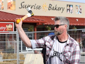 William Gordon demonstrates axe throwing at the Ford City Retro Camp Festival at the Windsor City Market on Sept. 1, 2017.