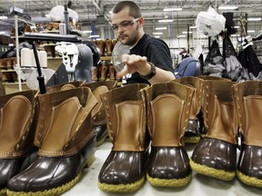 FILE - In this Dec. 14, 2011, file photo, Eric Rego stitches boots in the facility where LL Bean boots are assembled in Brunswick, Maine.