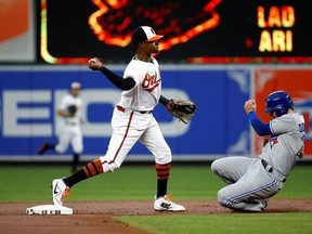 Baltimore Orioles shortstop Tim Beckham, left, throws to first base for a double play after forcing out Toronto Blue Jays&#039; Josh Donaldson, right, at second on Kendrys Morales&#039; ground ball in the first inning of a baseball game in Baltimore, Thursday, Aug. 31, 2017. (AP Photo/Patrick Semansky)