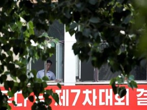 North Korean workers chat at each other near a window of North Korean Embassy in Beijing, Monday, Sept. 4, 2017. U.S. Defense Secretary Jim Mattis on Sunday shot back at North Korea&#039;s claimed test of a hydrogen bomb with a blunt threat, saying the U.S. will answer any threat from the North with a &ampquot;massive military response ‚Äî a response both effective and overwhelming.&ampquot; Earlier, U.S. President Donald Trump threatened to halt all trade with countries doing business with the North, a veiled warni