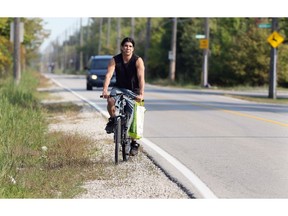 Jason West rides his bicycle on the shoulder of South Cameron Boulevard on Friday September 15, 2017.   There are no bike lanes on the roadway.