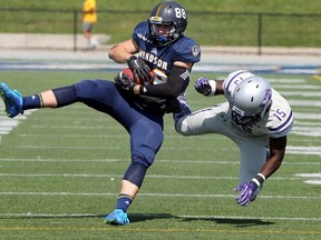 Windsor, Ontario. September 16, 2017.  University of Windsor Lancers wide receiver Brandon Speller snags a pass in front of Western Mustangs Bleska Kambamba, right,  in OUA action from University of Windsor Alumni Field on Saturday. (NICK BRANCACCIO/Windsor Star)