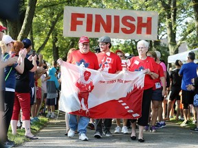 Cancer survivors David Dauphinee, left, Aleks Stajdohar and Norma Forget, right, carry the Terry Fox banner at the start of Tecumseh's Terry Fox Run September 17, 2017. A former RCMP officer, Dauphinee actually met Terry Fox in Corner Brook, Newfoundland during the early stages of his historic run.