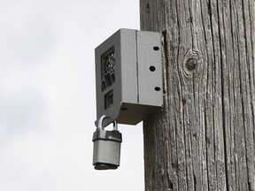 A hidden camera is seen mounted on a hydro pole on Munich Court, part of the Twin Oaks Industrial park near Lauzon Parkway, on Sept. 20, 2017. The camera box, mounted about two metres above the roadway, will help identify illegal dumping.
