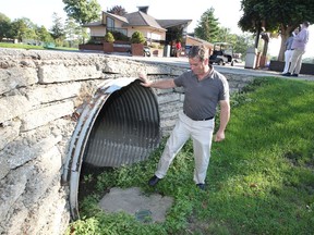 Phil Roberts, general manager at Roseland Golf and Curling Club, checks a culvert on Sept. 20, 2017, which connects the old Lennon Drain on the ninth hole. Construction will begin shortly on a project to bring water back to the Donald Ross designed course.