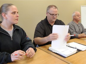 Unifor executive members Danielle Bojaruniec, left, Ken DesRosiers and Tullio DiPonio prepare to meet Sept. 30, 2017, with members of Unifor Local 2458 to discuss a labour dispute with Medical Laboratories of Windsor.