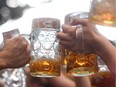 Visitors of the Oktoberfest beer festival clink their beer glasses on Sept. 24, 2017, at the Theresienwiese fair grounds in Munich.