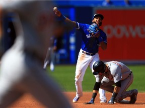 Richard Urena of the Toronto Blue Jays attempts a double play after forcing Nick Castellanos out but fails in the fourth inning during MLB game action against the Detroit Tigers at Rogers Centre on September 10, 2017 in Toronto, Canada.