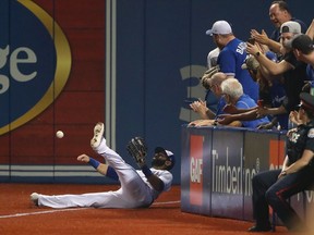 Jose Bautista of the Toronto Blue Jays throws the ball back in after making a sliding catch in the third inning of a MLB game against the Kansas City Royals at Rogers Centre on Sept. 19, 2017 in Toronto.