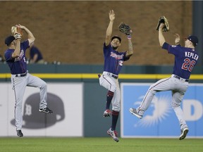Zack Granite, left, of the Minnesota Twins celebrates with teammates Byron Buxton, middle, and Max Kepler after a 12-1 win over the Detroit Tigers at Comerica Park on Sept. 21, 2017 in Detroit.