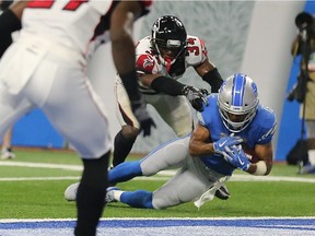 With his knee on the turf, Lions receiver Golden Tate catches the ball as the Falcons’ Brian Poole touches him in the dying seconds of the fourth quarter at Ford Field on Sept. 24, 2017, in Detroit. The play was originally ruled a touchdown but was overturned after the officials viewed the play and the game was over giving Atlanta a 30-26 victory over Detroit.
