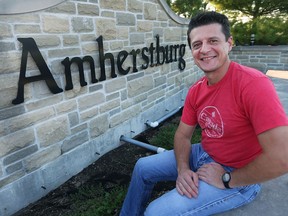 Amherstburg Mayor Aldo DiCarlo sits in front of a sign at the east entrance of town on Sept. 22, 2017.